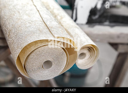 two rolls of wallpaper lying on the table closeup Stock Photo