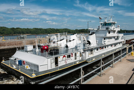 Mississippi Barge Boat  Description:  A towboat pushes freight barges through a lock on the Mississippi River. Stock Photo