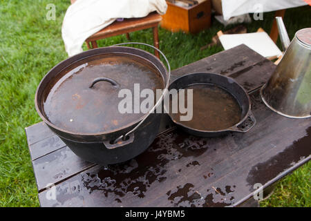 Cast iron pot and skillet on table, outdoors - USA Stock Photo