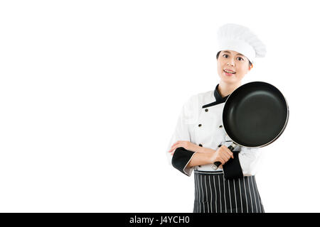 smiling chef isolated on white background showing a blank pan and standing in a blank copyspace with a restaurant advertising area. profession and ind Stock Photo