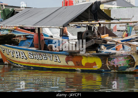 Fisherman asleep on his boat, Sunda Kelapa Harbour, Jakarta, Indonesia Stock Photo