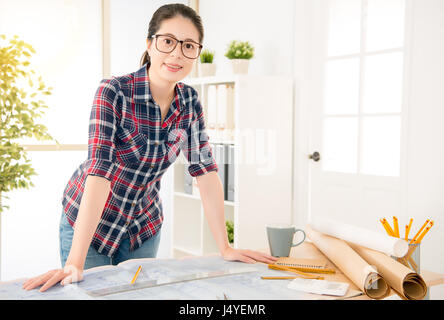 Young architect work project. Photo woman working with new startup project on wood table while at the desk in creative office studio. profession and j Stock Photo