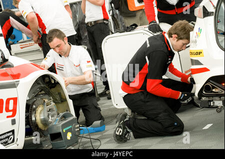 Mechanics from the Honda Yuasa racing team working on vehicles at the British Touring Car Championship in Thruxton, UK Stock Photo