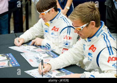 THRUXTON, UNITED KINGDOM - MAY 1: Team Aon drivers Tom Chilton and Andy Neate signing autographs at the British Touring Car Championship race meeting. Stock Photo