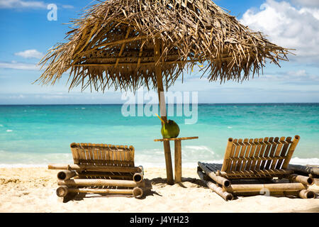 Beach chairs with sunshade and beautiful sand beach Stock Photo