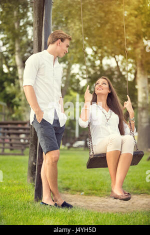 relationship and dating concept - romantic couple in the park Stock Photo