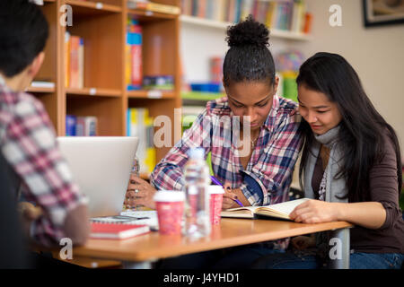Couple of female students studying for exam after lecture in college Stock Photo