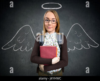 schoolgirl with funny angel wings and nimbus Stock Photo