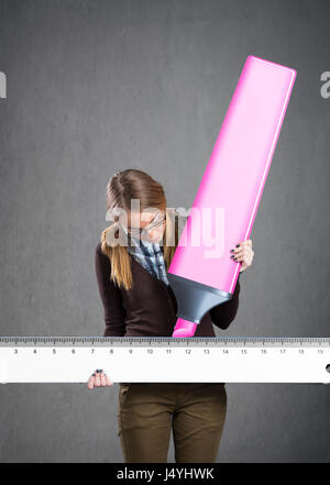 student girl drawing  with a ruler and marker Stock Photo