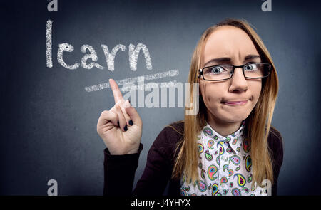 Nerd girl  with facial expression pointing in word learn Stock Photo
