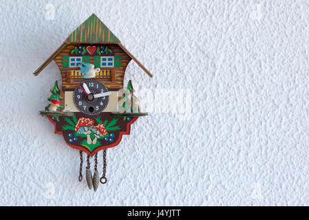 A cuckoo clock hanging on the wall Stock Photo