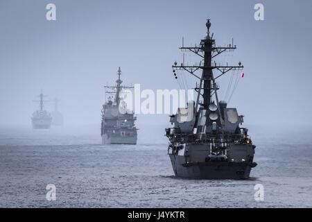 The guided-missile destroyers USS Sampson and USS Higgins transit the ...