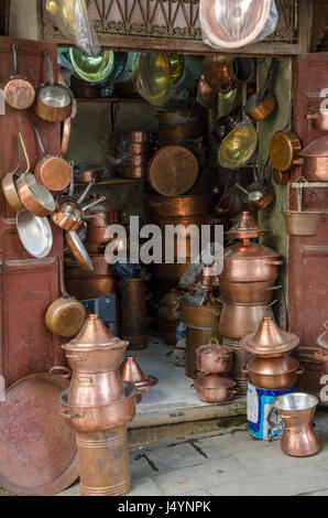Copper ware shop with crockery, pots and pans in the metal work part of Fez' soukh, Morocco. Stock Photo