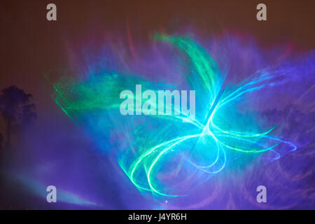 Colorful laser illumination show at night. Abstract blue light projector Stock Photo