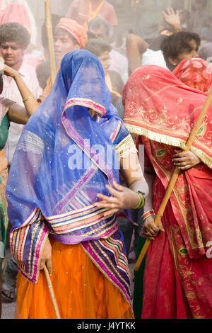 People celebrating lathmar holi festival, mathura, uttar pradesh, india, asia Stock Photo