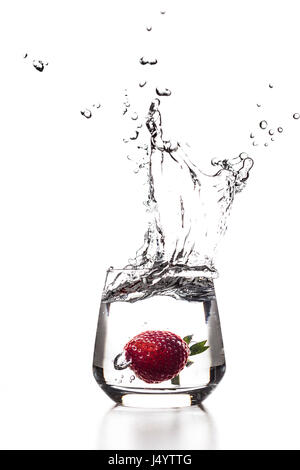 Astrawberry isfalling in a cocktail glass of water with splashes Stock Photo