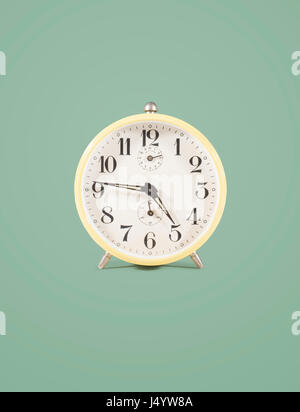 isolated retro alarm clock on colored background Stock Photo