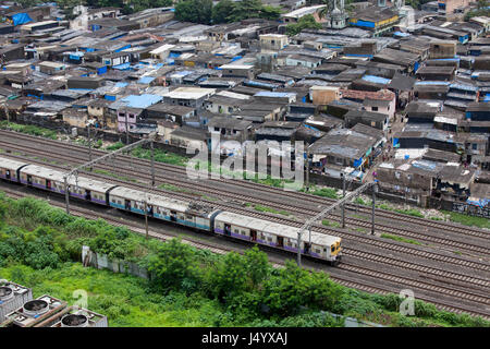 Local train and slums at kanjurmarg station, mumbai, maharashtra, india, asia Stock Photo