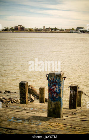 Steps down to the Mississippi between Toulouse St and St Peters Street in the French Quarter of New Orleans. Looking across to Algiers Point. Stock Photo