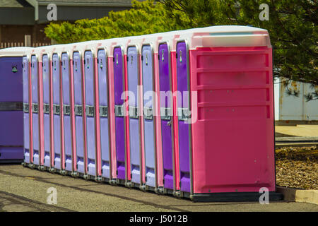 Row Of Portable Toilets At Park Stock Photo