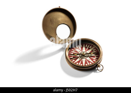 Old brass vintage compass for navigation opened to display the compass rose and needle on a white background with shadow Stock Photo