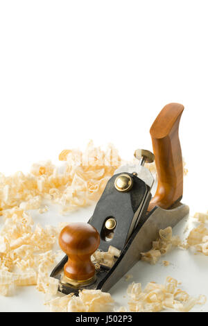 Woodworking hand planer tool on wooden boards in carpenter's workshop against white background with copy space Stock Photo