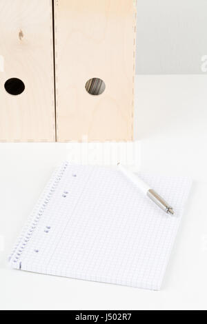 White office desk with empty notepad, pen and folders - study or workplace background mock up Stock Photo