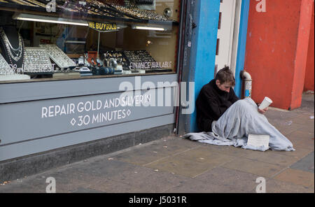 Homeless young man begging on the streets in Peckham in London,UK Stock Photo