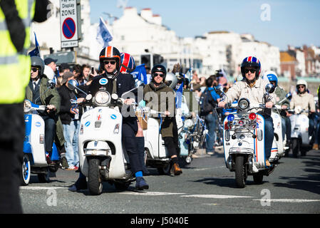 Brighton, England, Uk. 14th May, 2017. Brighton, East Sussex. 14th May 2017. Football fans gather as Brighton & Hove Albion F.C. are honoured with a 90 minute seafront parade in Brighton, from Palace Pier to Hove Lawns, to celebrate their promotion into the Premier League. The promotion of the Championship side will see the team playing top flight football next season for the first time in 34 years. The open top bus convoy is carrying Albion's players, staff and directors, as well as Brighton & Hove City Councillors. Credit: Francesca Moore/Alamy Live News Stock Photo