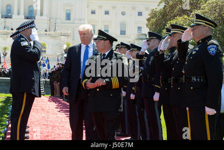 President Donald Trump applauds as he arrives to introduce a government ...