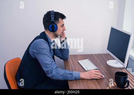 handsome man in call center with headphones Stock Photo