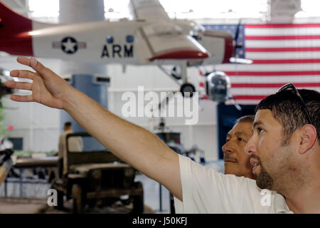 Alabama Dale County,Ft. Fort Rucker,United States Army Aviation Museum,Hispanic man,men,father dad,parent parents,aircraft,military,jeep,combat,exhibi Stock Photo