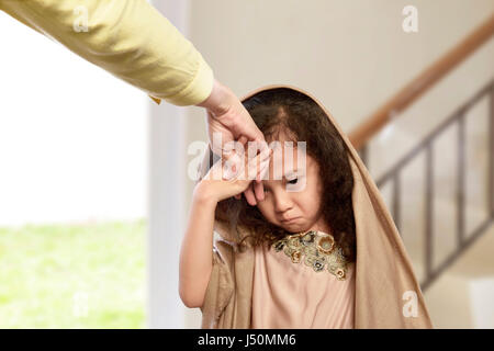 Asian muslim girl kissing hand parents as respect in the home Stock Photo