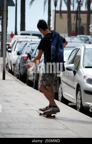 Young man skateboarding along the street, Cadiz, Cadiz Province, Andalusia, Spain, Western Europe. Stock Photo