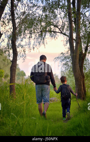 Father and son walking in spring forest Stock Photo