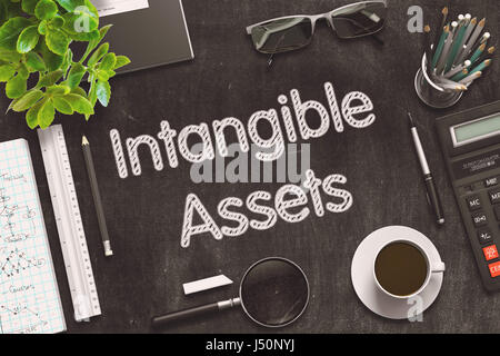 Intangible Assets - Text on Black Chalkboard. 3D Rendering. Stock Photo