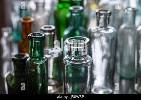 Old empty glass bottles, closeup photo with selective focus Stock Photo