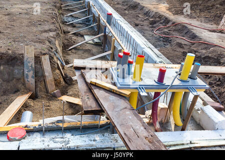 Foundation with pipes on construction site of new house Stock Photo