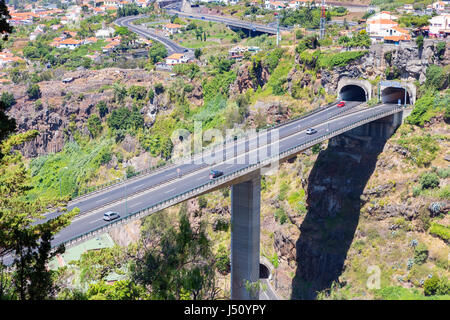 Cars driving on highway and overpass through tunnels at Madeira Portugal Stock Photo