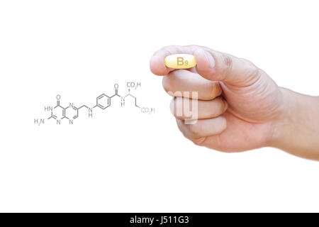 Hand holding vitamin B9 pill with clipping path Stock Photo