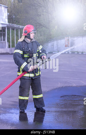 Water extingisher in hands, close up view. Stock Photo