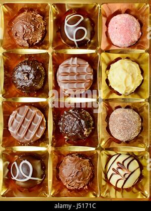 Top View of Belgian Chocolate Pralines in the Box. Sweet Pralines Close Up Background. Stock Photo
