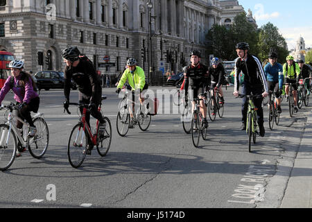 Commuters cyclists commute riding bikes near Parliament Square outside the Houses of Parliament in Westminster, London England UK  KATHY DEWITT Stock Photo