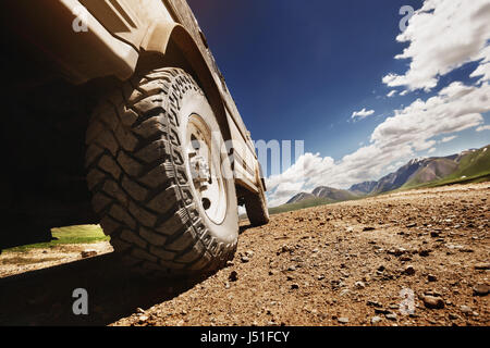 Big offroad car wheel on country road Stock Photo