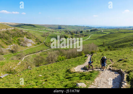 Walkers on the climb up to the top of Malham Cove, Malham, Malhamdale, Yorkshire Dales National Park, North Yorkshire, England, UK. Stock Photo