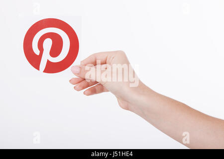 KIEV, UKRAINE - AUGUST 22, 2016: Woman hands holding Pinterest icon printed paper. Is photo sharing website. Stock Photo