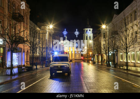 A police car while night patrolling of city streets . Stock Photo