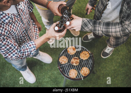 top view of young friends drinking beer and making barbecue Stock Photo