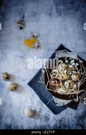 Fresh organic quail eggs in a bowl on vintage background Stock Photo