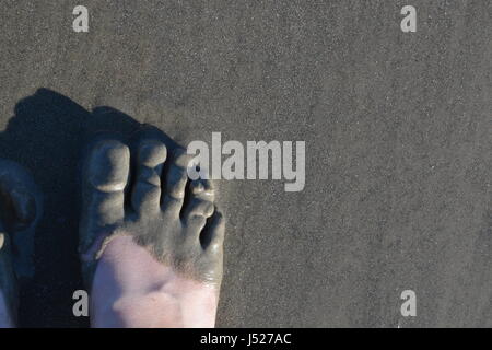 Foot consumed by sand Stock Photo